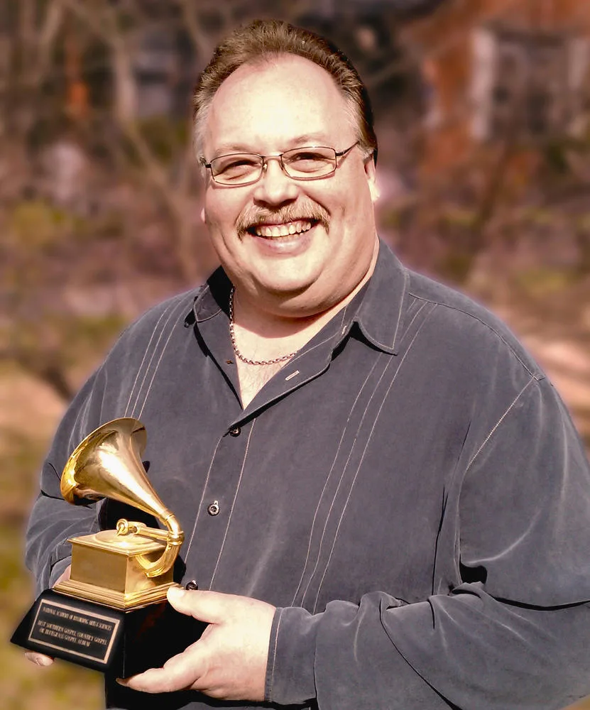 Michael D Clute holding his Grammy Award