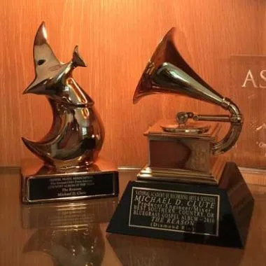 Michael D Clute's Grammy Award for Diamond Rio's The Reason, beside a second award trophy
